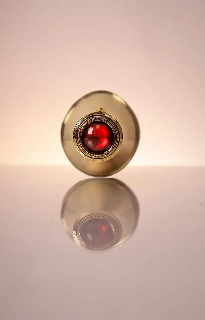 Vivandi Miracle Fruit Oil 30ml bottle with red accent, showcasing its unique design and reflection on a surface.